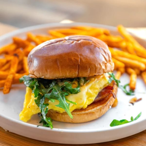 Take Ur Seat's brunch egg and arugula sandwich with a side of crispy fries.